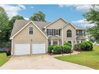 Charming two-story home featuring a two-car garage and well-maintained landscaping at 4015 Soaring Dr, Douglasville, GA 30135