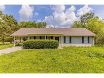 Charming single-story home with a covered carport and a well-maintained lawn and landscaping at 67 Jennifer Ln, Rydal, GA 30171