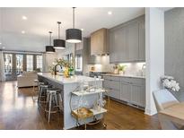 Bright, open kitchen with gray cabinetry, large island, and pendant lighting at 726 Edgewood Ne Ave, Atlanta, GA 30307