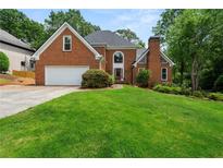 Charming two-story brick home with well-manicured lawn and attached two car garage at 1703 Brandywine Ct, Atlanta, GA 30338
