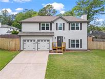 Charming two-story home featuring a spacious two car garage and a well-manicured lawn at 1923 Hamby Place Nw Dr, Acworth, GA 30102
