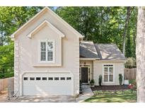 Charming home featuring an attached two-car garage and complemented by lush landscaping at 3376 Hickory Ln, Powder Springs, GA 30127