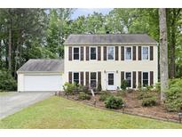 Charming two-story home with brown shutters, attached two-car garage, and a landscaped front yard at 4468 Whitt Station Nw Run, Acworth, GA 30101