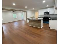 Modern kitchen with white cabinets, island, and stainless steel appliances at 472 Rigby Ne St, Marietta, GA 30060