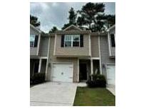Charming townhome featuring a one-car garage, neutral siding, and a well-maintained front yard at 107 Highwood Ln, Atlanta, GA 30344