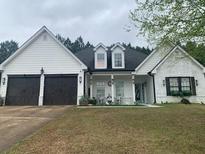 Charming single-story home featuring a large two-car garage, covered entryway, and landscaped front lawn at 51 Norton Ave, Acworth, GA 30101