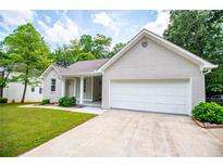 Charming single-story home featuring an attached garage, manicured lawn, and inviting curb appeal at 9691 Squirrel Wood Run, Douglasville, GA 30135
