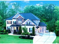 Beautiful two story home with stone accents and a well manicured front yard and driveway at 3755 Valleyway Rd, Cumming, GA 30040
