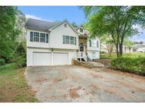 Charming two-story home with a two-car garage and a well-manicured front yard at 3140 Willow Park Dr, Dacula, GA 30019