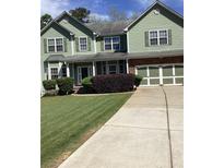 Charming two-story home with a well-manicured lawn and a spacious driveway at 6074 Locklear Way, Douglasville, GA 30134