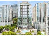Stunning exterior view of high-rise building with balconies, pool, and cityscape in the background at 222 12Th Ne St # 1508, Atlanta, GA 30309