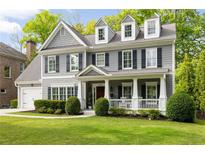 Beautiful two-story home with gray siding, black shutters, dormer windows and well-manicured landscaping at 1446 Wilford Ne Dr, Atlanta, GA 30319