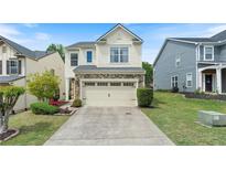 Charming two-story home with stone accents and well-manicured landscaping at 6065 Falls Landing Dr, Cumming, GA 30040