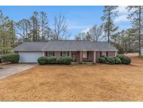 Charming single-story brick home with a well-maintained yard and attached garage at 10 Mcgiboney Pl, Covington, GA 30016
