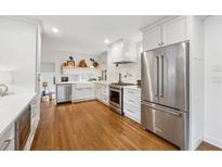 Bright kitchen features stainless steel appliances, hardwood floors, and white cabinetry at 3772 Evans Rd, Atlanta, GA 30340