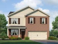 Charming two-story home with brick and siding, showcasing a well-maintained lawn and an attached two-car garage at 8228 Coldstream Dr, Fairburn, GA 30213