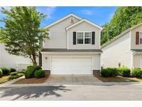 Charming two-story home with attached two-car garage, beautiful landscaping and neutral colored siding at 202 Windcroft Nw Ct, Acworth, GA 30101