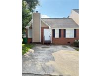 Charming brick home featuring a concrete driveway and inviting front entrance with a chimney at 2115 Charter Ln, Lithonia, GA 30058