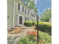 Charming townhome featuring neutral siding, well-maintained landscaping, and a welcoming entrance at 3407 Spring Harbour Dr # 2, Doraville, GA 30340