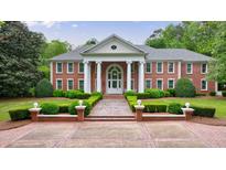 Stately brick home featuring manicured landscaping and a columned entrance at 4500 Candacraig, Alpharetta, GA 30022