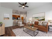 Bright living room featuring modern furnishings, hardwood floors and an open floor plan with a view into the kitchen at 384 Ralph Mcgill Ne Blvd # 318, Atlanta, GA 30312