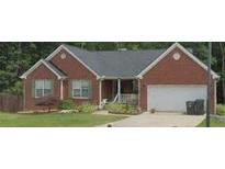 Charming brick home with a well-manicured front yard and attached garage, perfect for suburban living at 2582 Oak Bluff Dr, Dacula, GA 30019