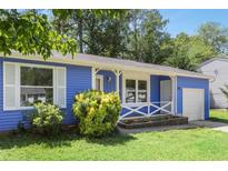 Charming blue home with white trim, tidy lawn, and tasteful landscaping enhancing its curb appeal at 1030 Brockdell Ct, Norcross, GA 30093