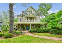 Charming two-story home with inviting front porch and lush landscaping at 185 Elizabeth St, Atlanta, GA 30307
