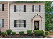 Charming two-story home featuring white siding, black shutters, and well-maintained landscaping at 285 Enterprise Path, Hiram, GA 30141