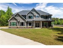 Stately two-story home featuring manicured lawn, detailed gables, and a welcoming front porch at 415 Paynes Lake Rd, Carrollton, GA 30116