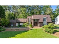 Charming home featuring a large front lawn and mature landscaping at 1178 Roxboro Ne Cv, Atlanta, GA 30324