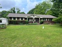 Charming brick home with a well-maintained front yard and mature landscaping, creating a welcoming curb appeal at 2659 Odum St, Snellville, GA 30078