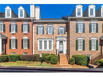 Charming brick townhome with manicured landscaping and classic architectural details at 4656 Ivygate Se Cir, Atlanta, GA 30339