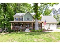 Charming two-story home with a welcoming front porch and well-manicured lawn at 5531 Hurstcliffe Nw Dr, Kennesaw, GA 30152
