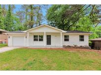 Charming one-story home with a well-maintained front yard and painted white brick at 1660 Mallard Cir, Conley, GA 30288