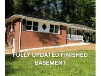 Charming brick home with a freshly landscaped yard and inviting front porch at 257 E Simon Nw Ter, Atlanta, GA 30318