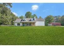 Charming home with stone accents, large front yard, and outbuilding at 3880 Dial Mill Ne Rd, Conyers, GA 30013