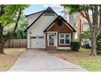 Charming home with a well-manicured front yard and a cozy exterior and a drive way that leads to a one car garage at 969 Oak Sw St, Atlanta, GA 30310