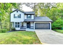 Charming two-story home with a well-manicured lawn and an attached two-car garage at 2211 Rocky Mill Dr, Lawrenceville, GA 30044