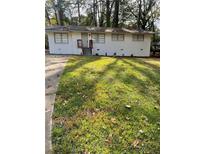 Charming single-story home with a well-maintained front yard and updated exterior at 735 Brookwood Dr, Forest Park, GA 30297