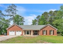 Charming brick home with a two-car garage and manicured lawn at 9959 Point View Dr, Jonesboro, GA 30238