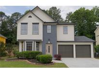Charming two-story home featuring a two-car garage and manicured front yard at 1075 Litchfield Sw Way, Marietta, GA 30060