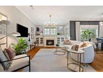 Inviting living room featuring a fireplace, modern furniture, and hardwood floors for comfortable living at 1242 Morton Trce Se Trce, Atlanta, GA 30316
