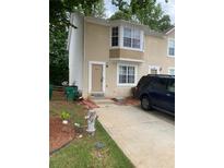 Inviting townhome featuring a front door and a large bay window that brightens the living space at 5047 Chupp Way Cir, Lithonia, GA 30038