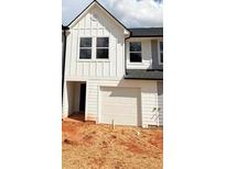 Charming new construction townhome with white siding and a single-car garage at 11608 E Lovejoy Rd, Hampton, GA 30228