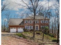 Charming brick home featuring a two-car garage and classic architectural details at 1463 Shadowrock Hts, Marietta, GA 30062