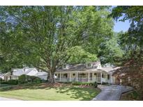 Charming home with large tree and welcoming front porch perfect for relaxing and curb appeal at 2515 Ridgewood Nw Rd, Atlanta, GA 30318