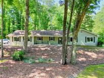 Charming single-story home featuring a well-maintained front yard and beautiful mature trees at 1379 Branchwood Dr, Snellville, GA 30078
