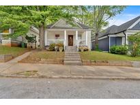 Charming bungalow with inviting front porch and steps leading up to the entrance at 902 Allene Sw Ave, Atlanta, GA 30310
