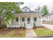Charming craftsman home featuring a welcoming front porch and well-maintained landscaping at 1555 New Ne St, Atlanta, GA 30307